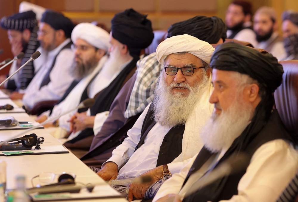 Members of the Taliban delegation during the presentation of the final declaration of the peace talks between the Afghan government and the Taliban in Doha. - AFP
