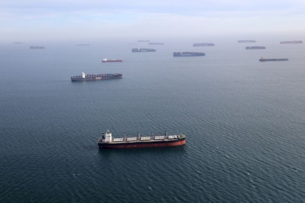Container ships and oil tankers wait in the ocean outside the Port of Long Beach-Port of Los Angeles complex in Los Angeles, California. — Reuters