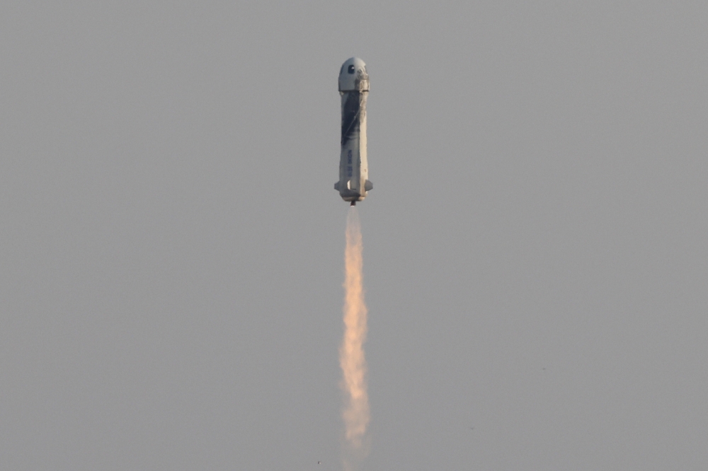 Jeff Bezos is launched with three crew members aboard a New Shepard rocket from Blue Origin's Launch Site 1 near Van Horn, Texas. - Reuters