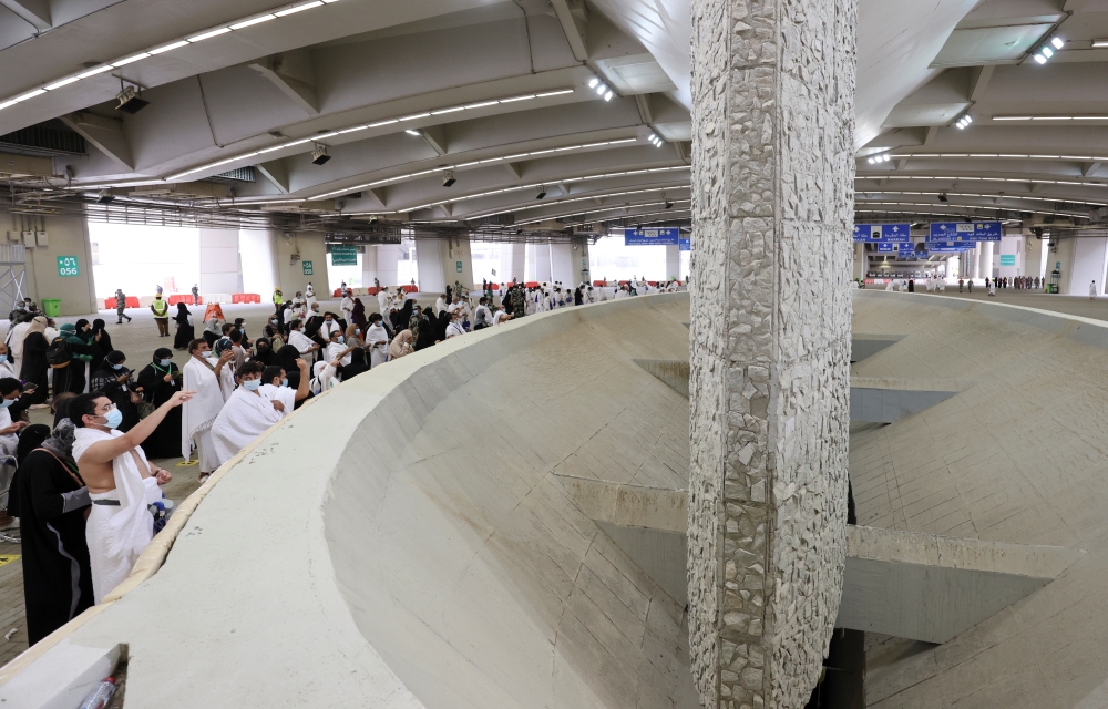 Pilgrims cast stones at pillars symbolising Satan during the annual Haj pilgrimage near the holy city of Mecca, Saudi Arabia, on Tuesday. - AFP