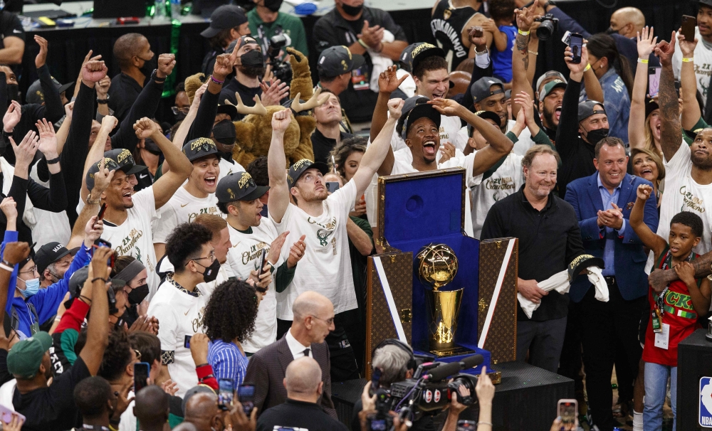 Milwaukee Bucks players celebrate after winning the NBA Championship following game six of the 2021 NBA Finals against the Phoenix Suns. -- USA Today Sports