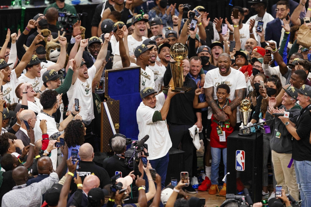 Milwaukee Bucks owner Wes Edens holds up the Larry O'Brien trophy following game six of the 2021 NBA Finals against the Phoenix Suns at Fiserv Forum. -- USA Today Sports