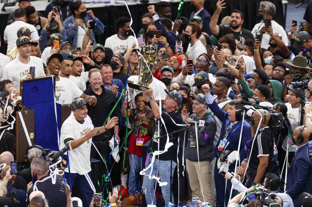 Milwaukee Bucks owner Wes Edens holds up the Larry O'Brien trophy following game six of the 2021 NBA Finals against the Phoenix Suns at Fiserv Forum. -- USA Today Sports