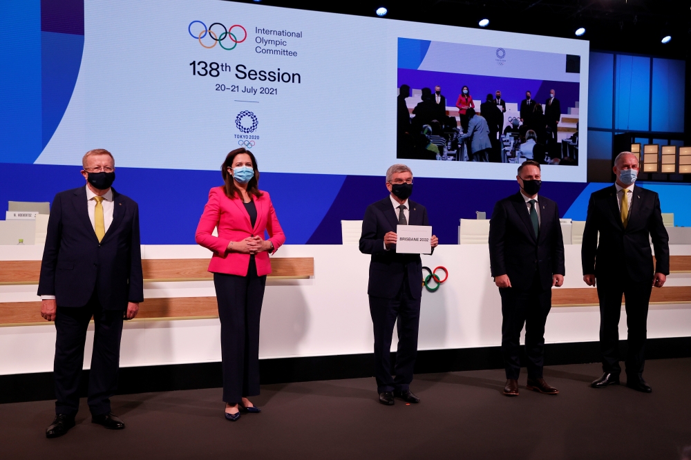IOC President Thomas Bach (C) poses with members of the Brisbane 2032 delegation after Brisbane was announced as the 2032 Summer Olympics host city during the 138th IOC session in Tokyo. -- Reuters