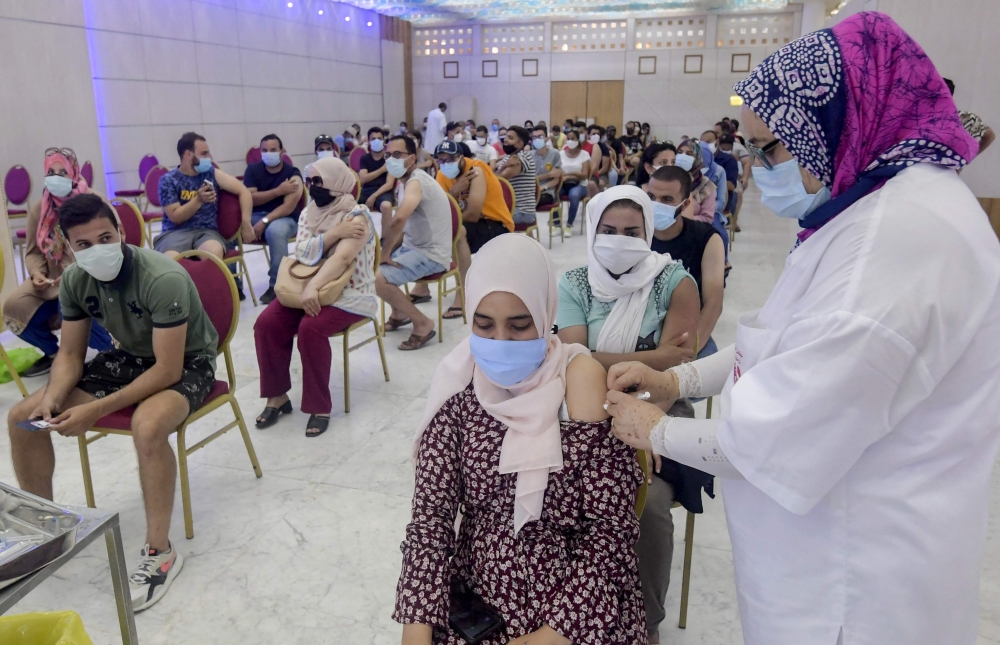 A Tunisian woman receives a dose of the Chinese Sinopharm vaccine at the Palais des Congres in the capital Tunis on Tuesday. - AFP