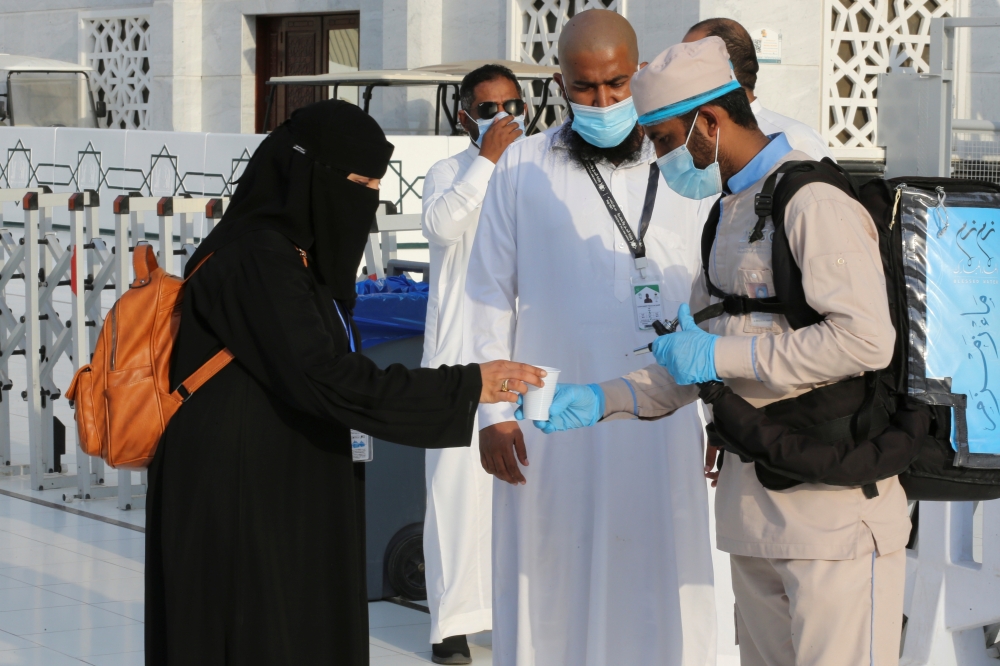 A worker distributes Zamzam water to pilgrims during the annual Haj pilgrimage, in the holy city of Mecca, Saudi Arabia. - Reuters