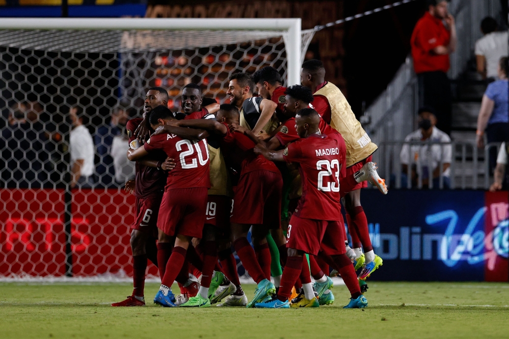 Qatar players celebrate after Abdelaziz Hatim scored a goal against Honduras during the Gold Cup in Houston. -- AFP