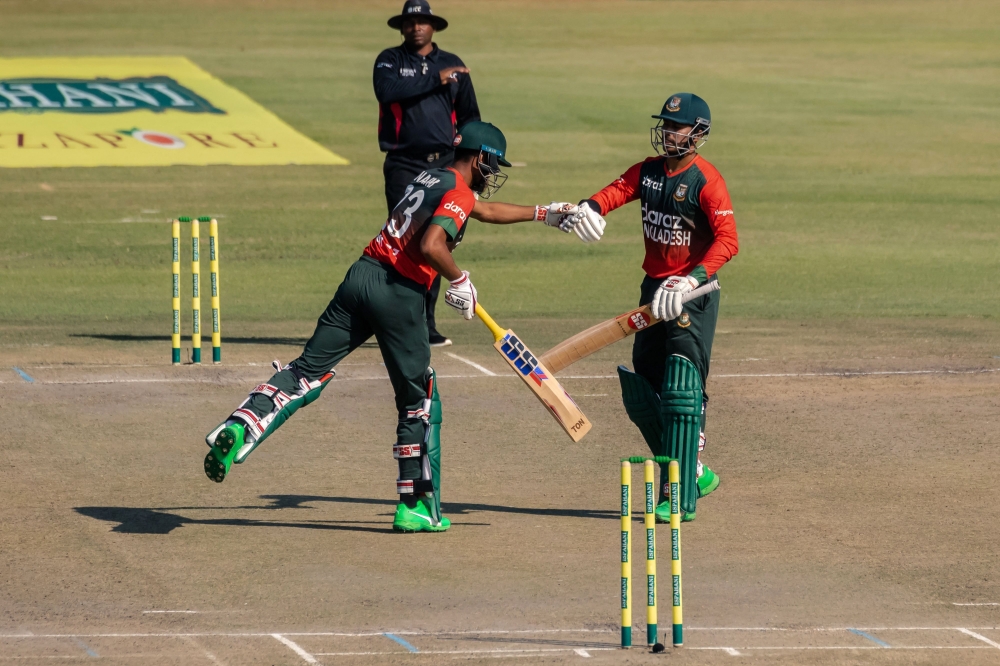 Bangladesh's Mohammed Naim (L) and Soumya Sarkar (R) fist bump during the first Twenty20 against Zimbabwe in Harare. -- AFP