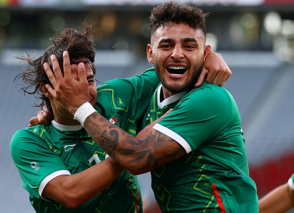 Alexis Vega of Mexico celebrates scoring their first goal with Diego Lainez. -- Reuters