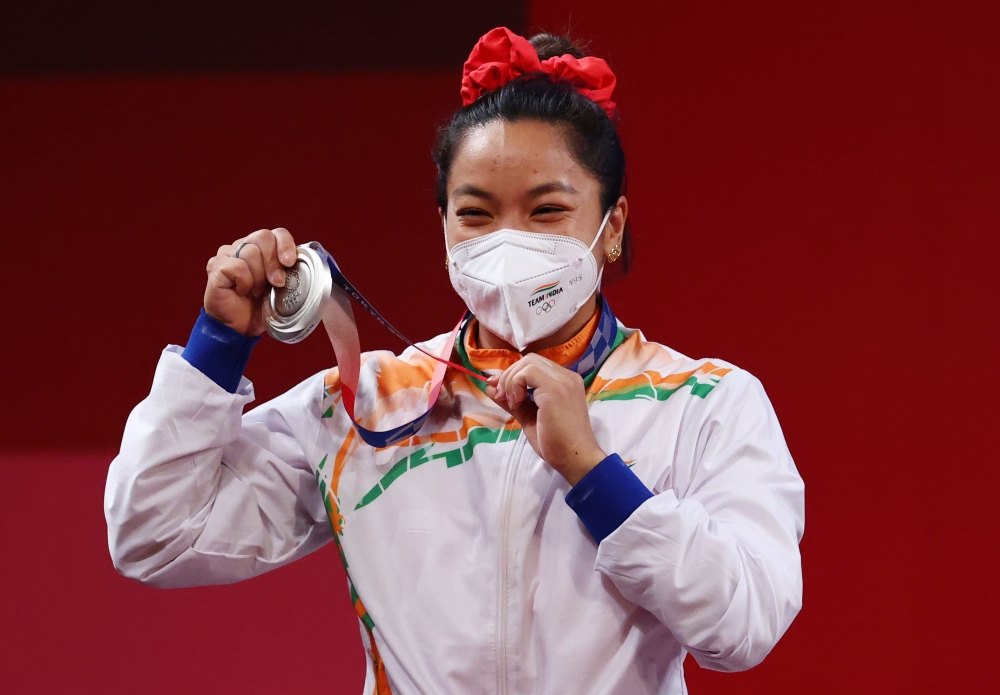 Silver medalist Mirabai Chanu Saikhom of India reacts. 