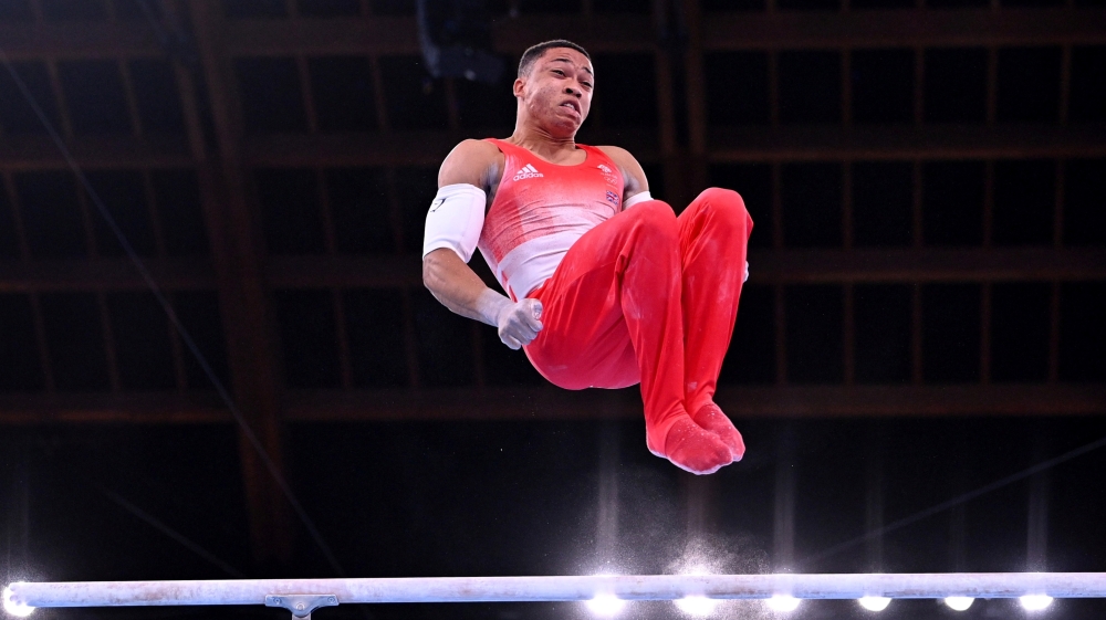 Joe Fraser of Britain in action on the parallel bars. REUTERS/Dylan Martinez
