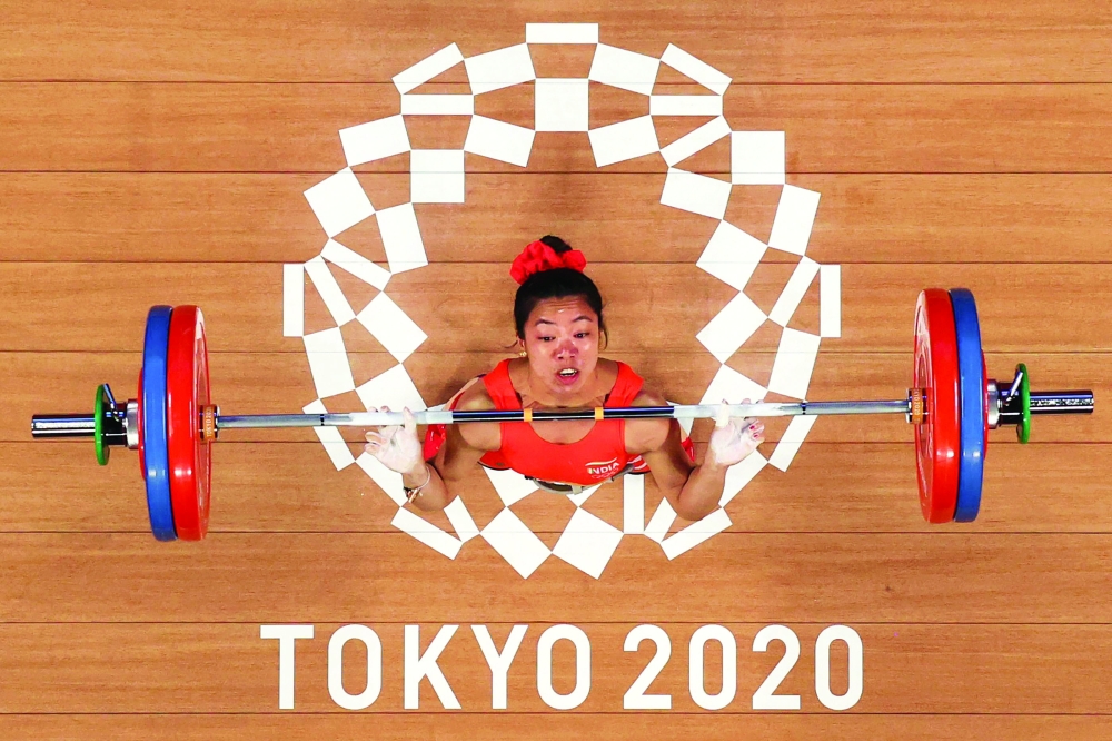 This picture taken with a robotic camera shows India's Chanu Saikhom Mirabai competing in the women's 49kg weightlifting competition during the Tokyo 2020 Olympic Games at the Tokyo International Forum in Tokyo. -- AFP