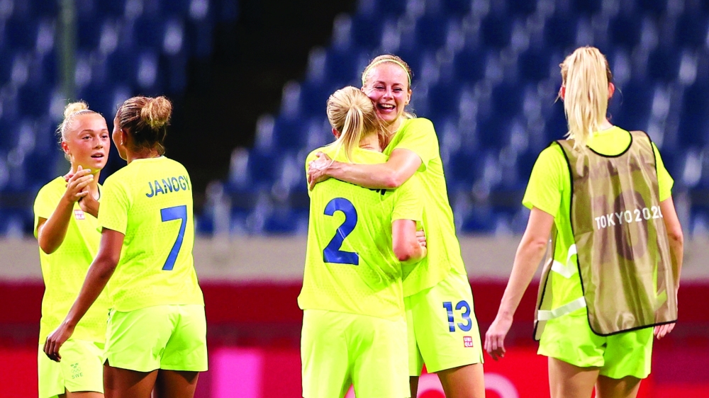 Jonna Andersson of Sweden and Amanda Ilestedt of Sweden celebrate after the match. -- Reuters