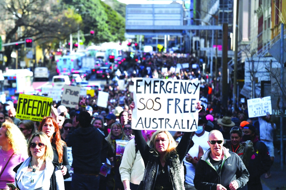 Protesters march through the city centre during an anti-lockdown rally as an outbreak of Covid-19 affects Sydney, on Saturday. - Reuters 