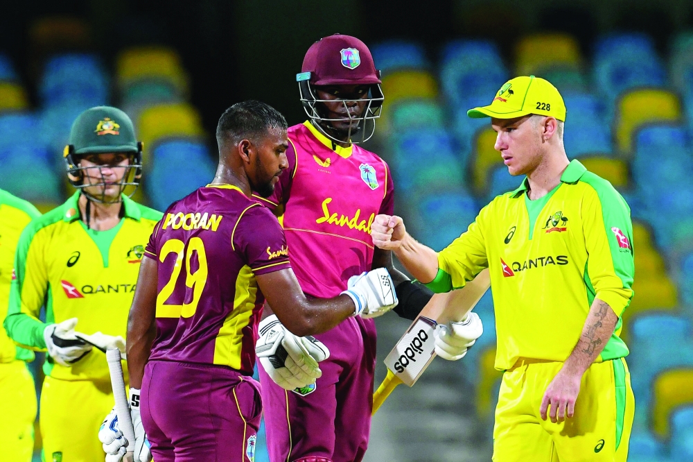 Nicholas Pooran (2L) and Alzarri Joseph (2R) of West Indies congratulated by Adam Zampa (R) of Australia for winning the 2nd ODI. -- AFP

