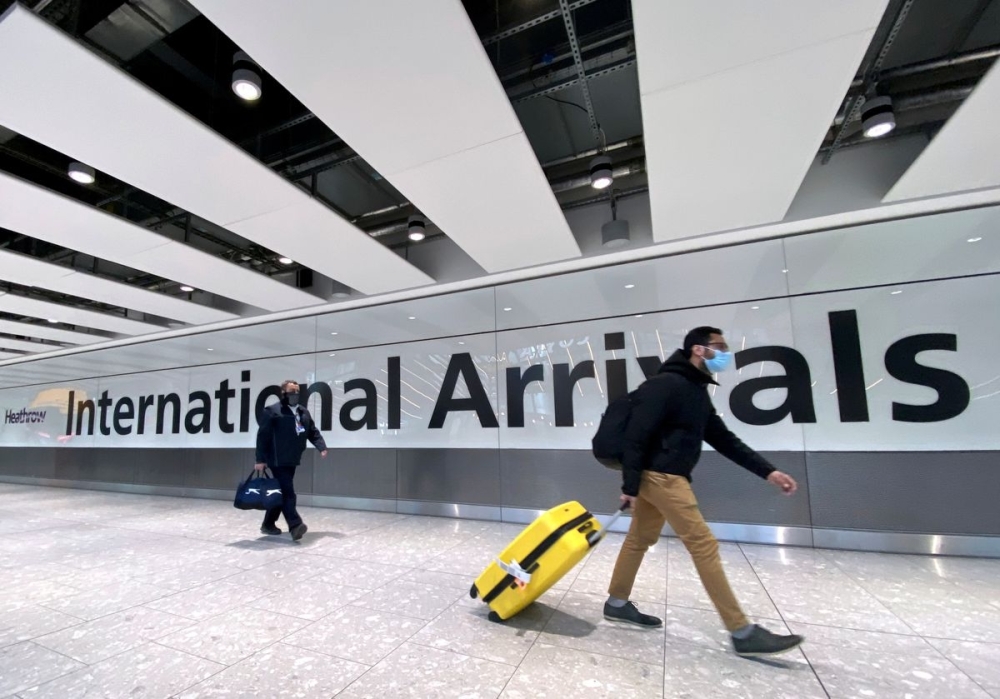 Travellers arrive at Heathrow Airport, London.