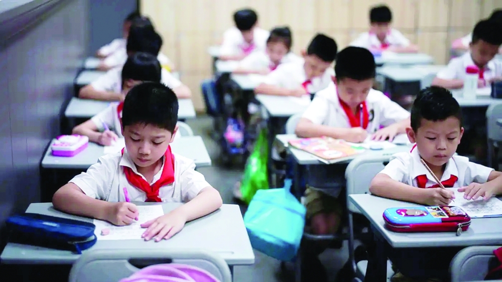 Primary students take exam inside a classroom in Beijing, China. — Reuters