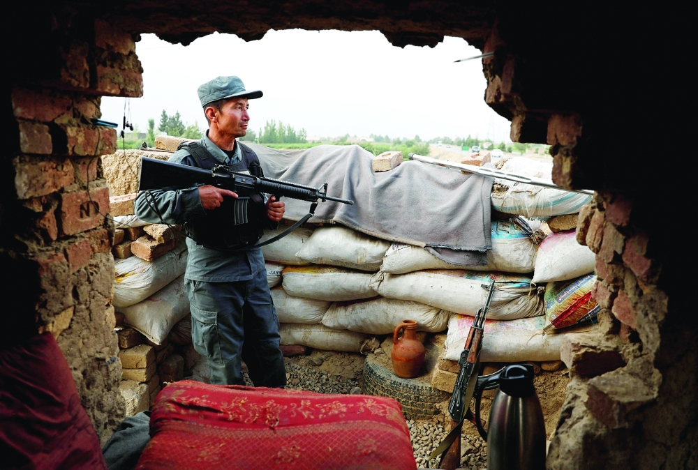 An Afghan policeman keeps watch at the check post on the outskirts of Kabul. - Reuters File Photo
