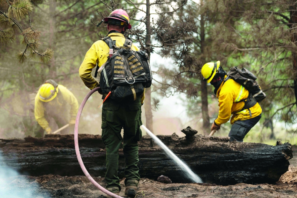 Fire crews do mop up work in Division Echo Echo of the Bootleg Fire in their efforts to fight the blaze in the Fremont-Winema National Forest of Oregon. - AFP