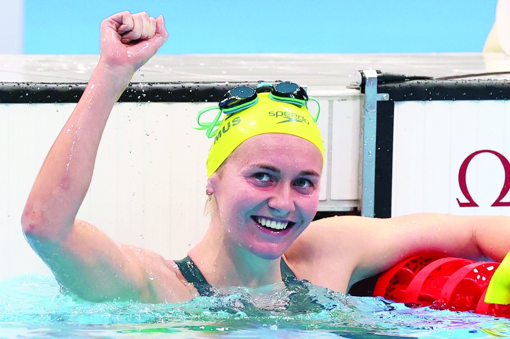 Ariarne Titmus of Australia celebrates winning gold in women's 400m freestyle swimming. -- Reuters