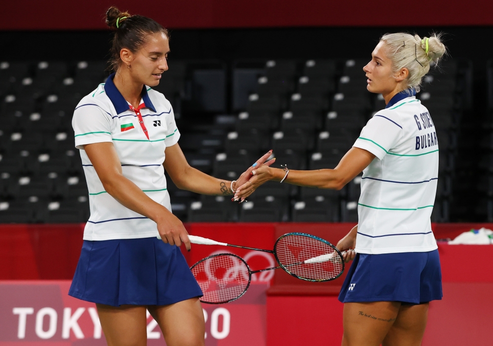 Tokyo 2020 Olympics - Badminton - Women's Doubles - Group Stage - MFS - Musashino Forest Sport Plaza, Tokyo, Japan - July 27, 2021. Gabriela Stoeva of Bulgaria and Stefani Stoeva of Bulgaria react during the match against Jongkolphan Kititharakul of Thailand and Rawinda Prajongjai of Thailand. 
