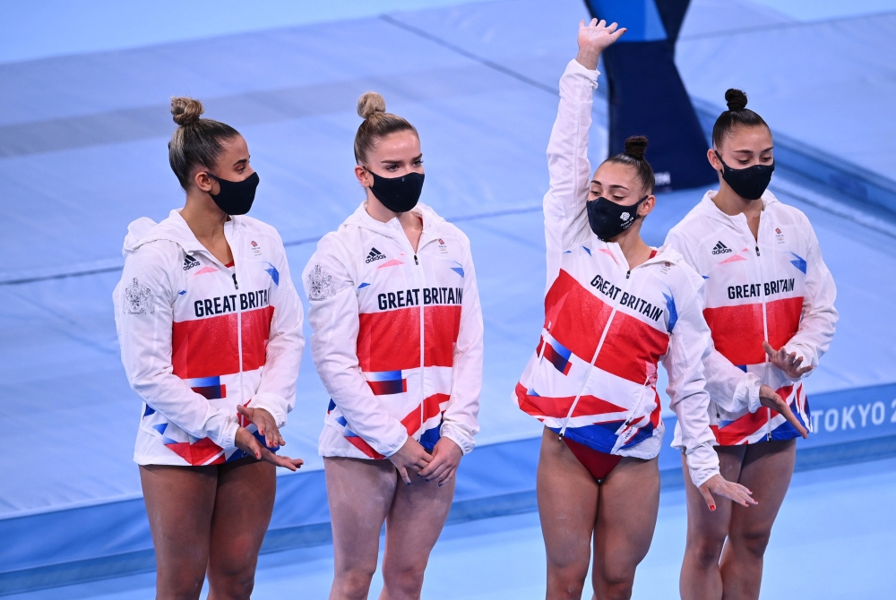 Jessica Gadirova of Britain waves alongside Jennifer Gadirova of Britain, Alice Kinsella of BritaiREUTERS/Dylan Martinez
