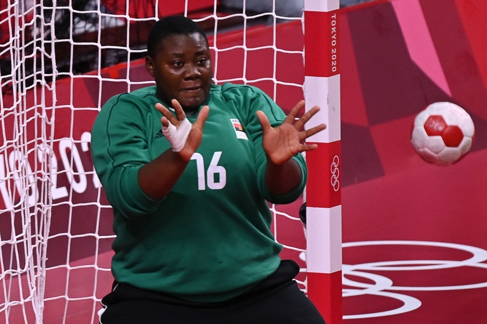 Angola's goalkeeper Teresa Almeida eyes the ball during the women's preliminary round group A handball match between Angola and Norway of the Tokyo 2020 Olympic Games at the Yoyogi National Stadium in Tokyo on July 27, 2021. 