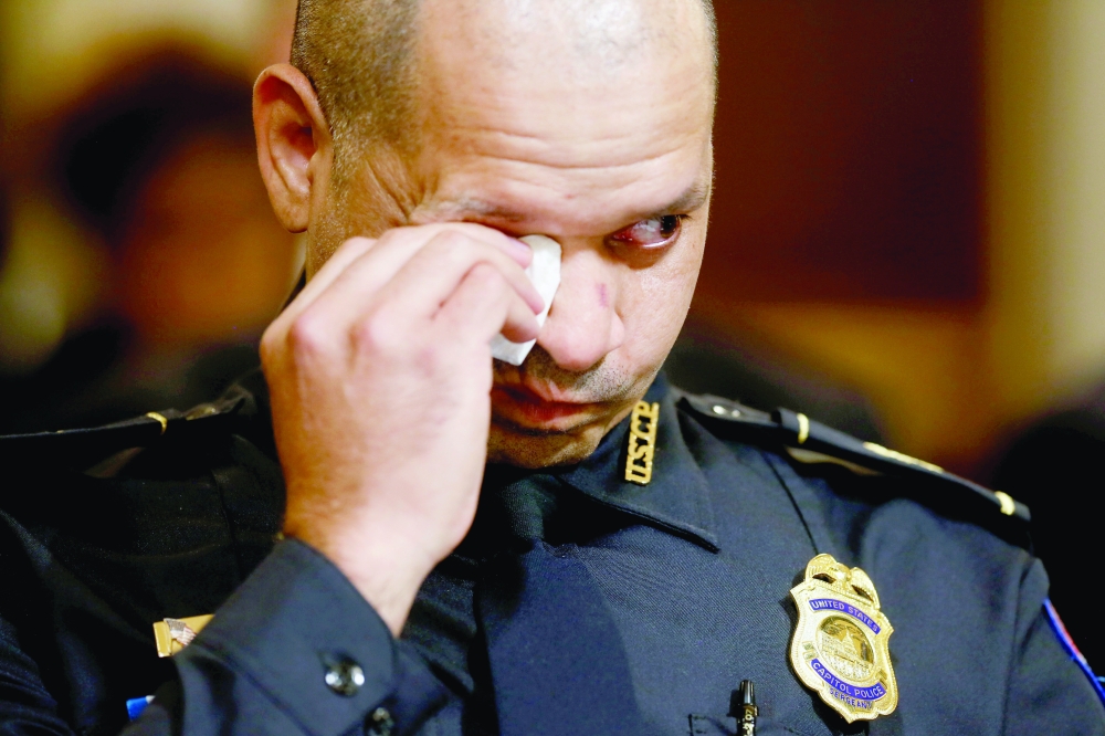 US Capitol Police sergeant Aquilino Gonell wipe tears prior to testifying before the opening hearing of the US House (Select) Committee investigating the January 6 attack on the US Capitol, on Tuesday. - Reuters