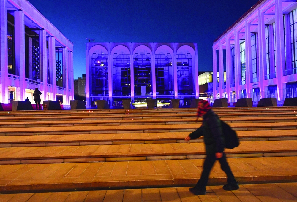 (FILES) In this file photo a person walks past the closed Metropolitan Opera at Lincoln Center on January 7, 2021 in New York City. New York's Metropolitan Opera will require audiences and performers to be fully vaccinated for its upcoming season, the house announced on July 27, 2021 amid debate in the United States about mandatory vaccinations. The Met said all customers, staff and members of its orchestra and chorus will need to show proof of vaccination against Covid-19 for performances in the 2021–22 season.
 (Photo by Angela Weiss / AFP)

