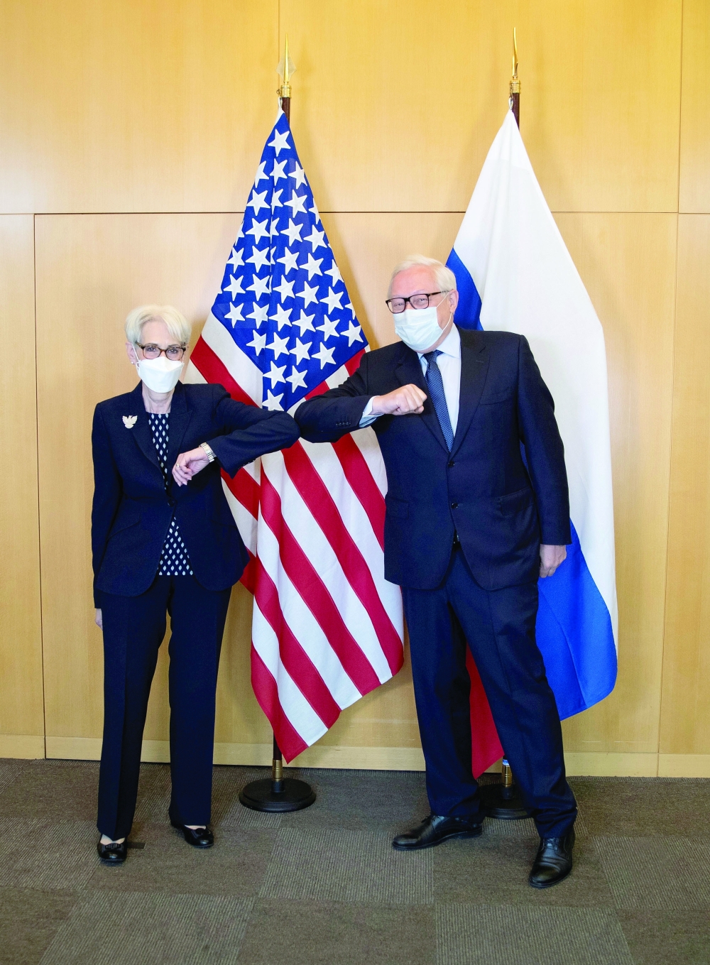 US Deputy Secretary of State Wendy Sherman (L) and Russian Deputy Foreign Minister Sergei Ryabkov pose in front of their national flags before a meeting at the US diplomatic mission in Geneva, Switzerland on Wednesday. - Reuters
