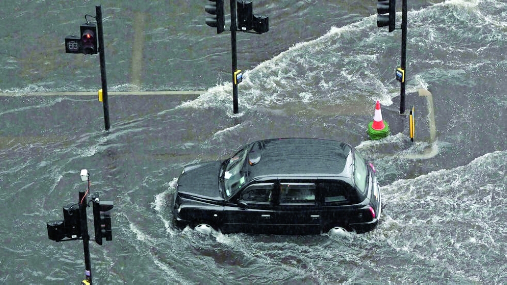 A report saying climate change has made the UK warmer and wetter comes after flash flooding and a mini-heatwave in England last week. - AFP