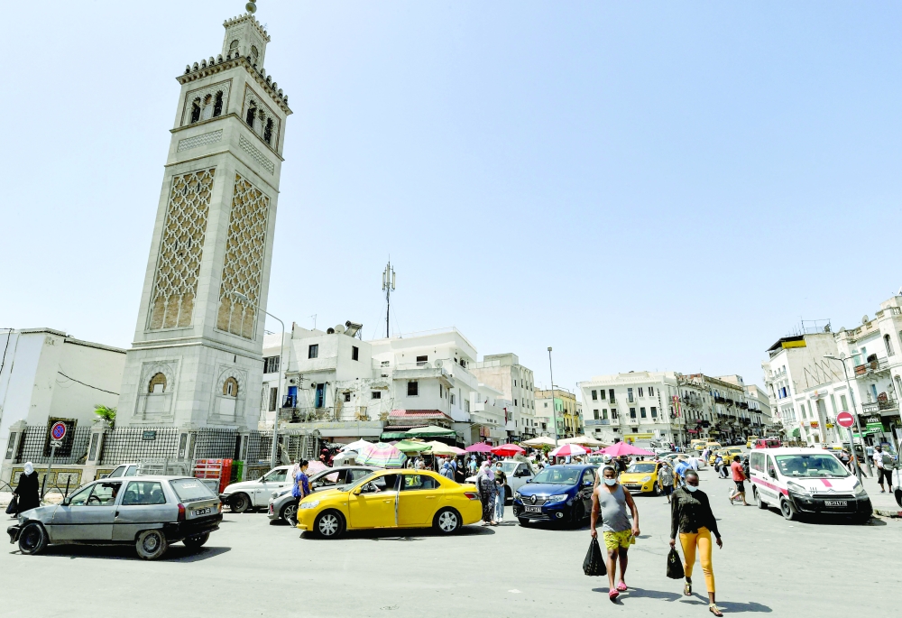 People walk past the Sidi Bashir mosque in the Bab el Fellah area of Tunis. - AFP