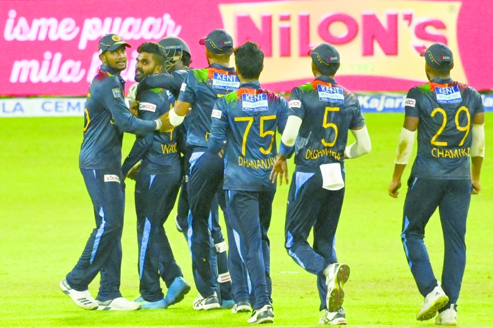 Sri Lanka's Wanindu Hasaranga (2L) celebrates with his teammates after the dismissal of India's Sanju Samson. -- AFP