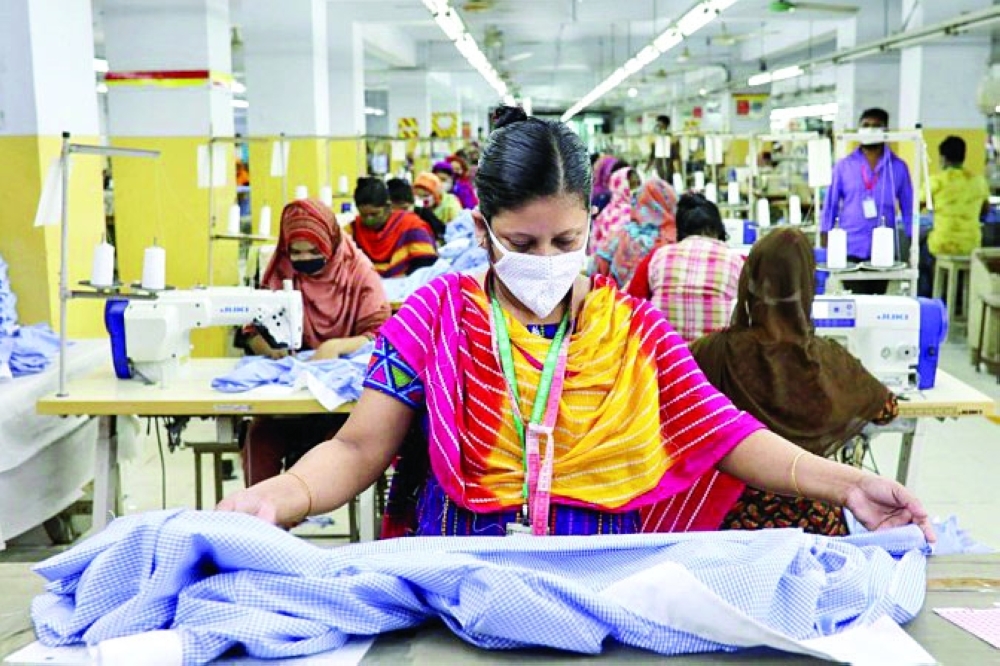 A woman works in a garment factory in Dhaka. — Reuters