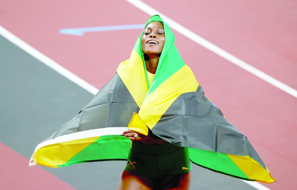 Gold medallist Elaine Thompson-Herah of Jamaica celebrates after winning. -- Reuters