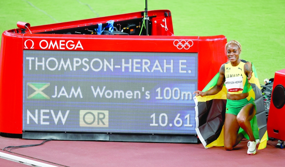 Gold medallist Elaine Thompson-Herah of Jamaica celebrates after winning and setting an Olympic Record. -- Reuters