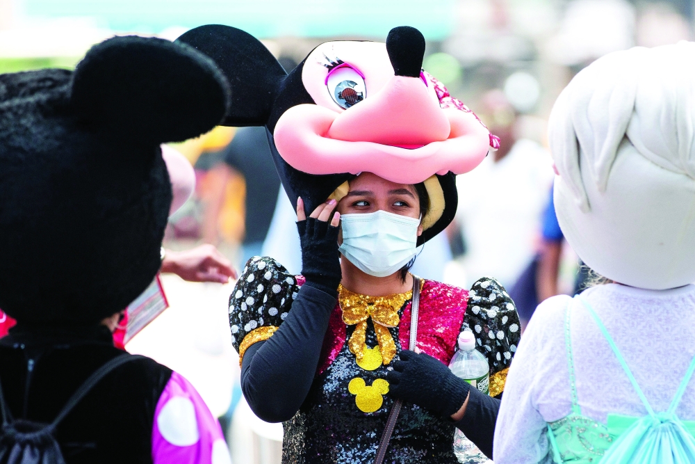 A woman costumed as Minnie Mouse wears a mask to prevent against the spread of coronavirus disease as the highly transmissible Delta variant has led to a surge in infections in New York City. - Reuters
