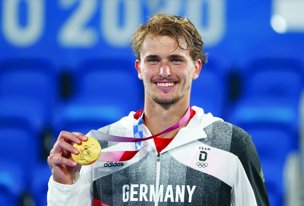 Gold medallist Alexander Zverev of Germany celebrates on the podium REUTERS