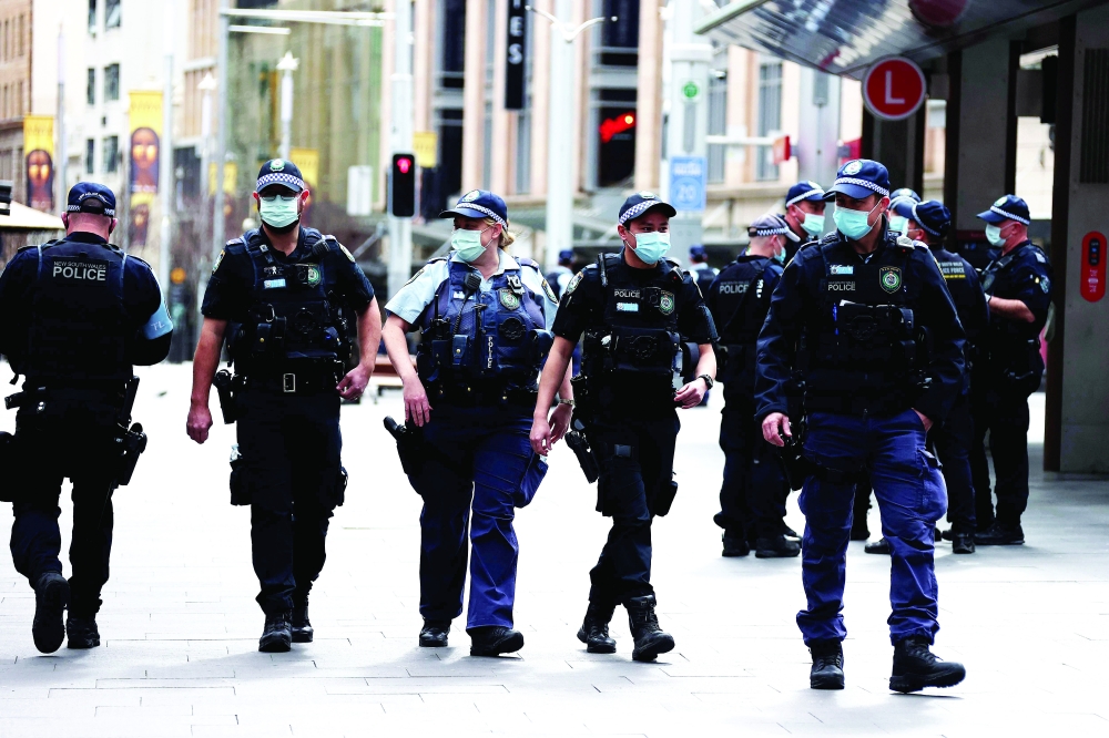 Police officers patrol the streets of central business district of Sydney as authorities warned against the anti-lockdown protest. - AFP