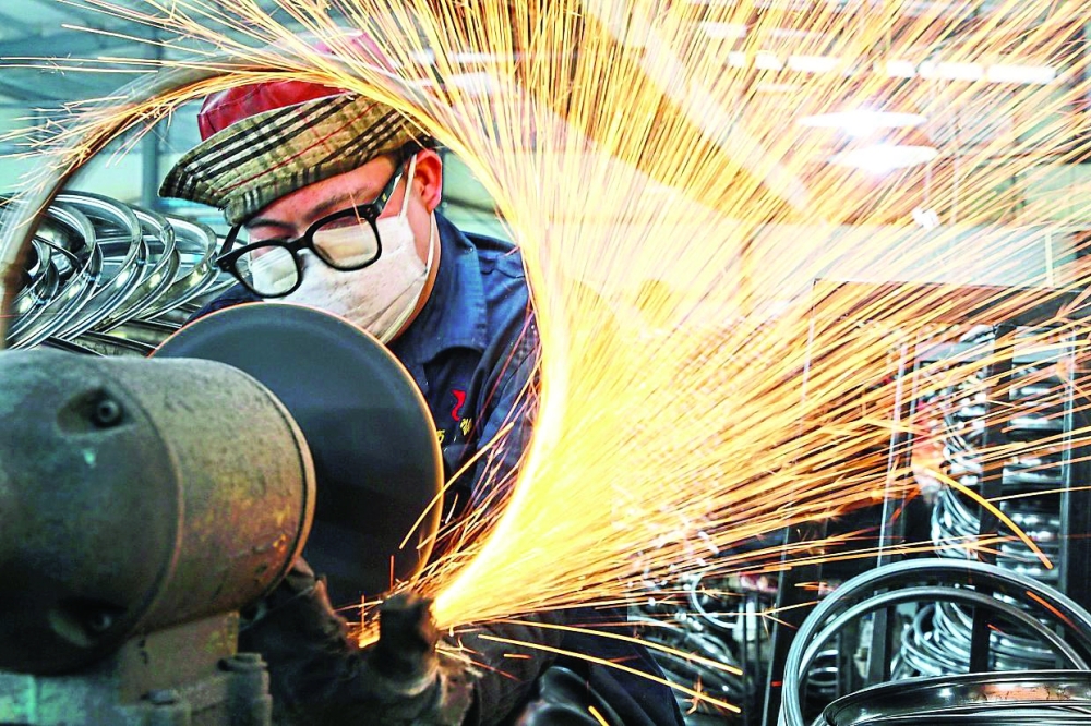 A worker welds wheels at a factory in Hangzhou in China’s eastern Zhejiang province. — Reuters
