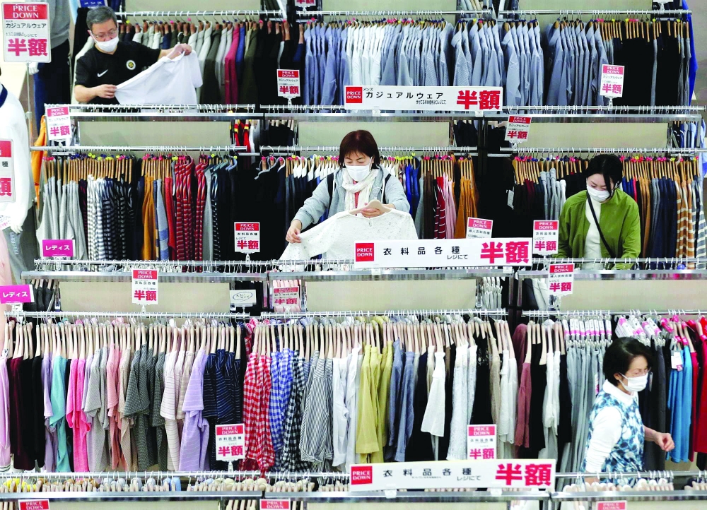 Shoppers choose clothes at a shopping mall in Chiba, Japan. — Reuters