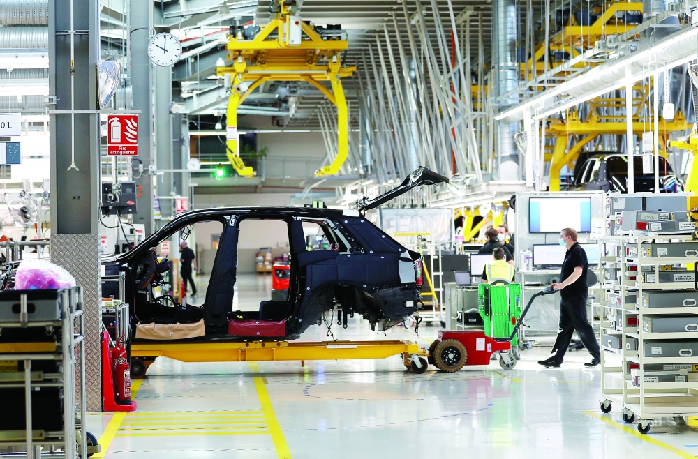 A technician moves the body of a car on the production line of the Rolls-Royce Goodwood factory, near Chichester, Great Britain. — Reuters