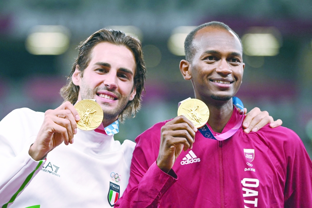 Joint gold medalists Qatar's Mutaz Essa Barshim (R) and Italy's Gianmarco Tamberi pose on the podium. -- AFP