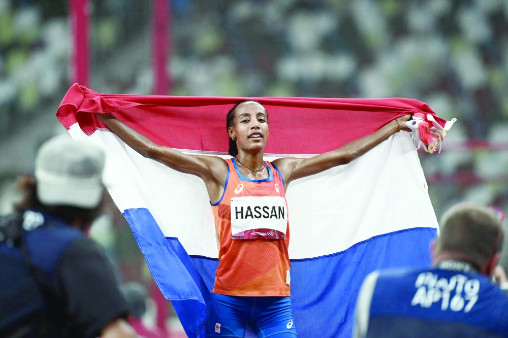 Netherlands' Sifan Hassan reacts after winning the women's 5000m final during the Tokyo 2020 Olympic Games at the Olympic Stadium in Tokyo on August 2, 2021. (Photo by Jewel SAMAD / AFP)

