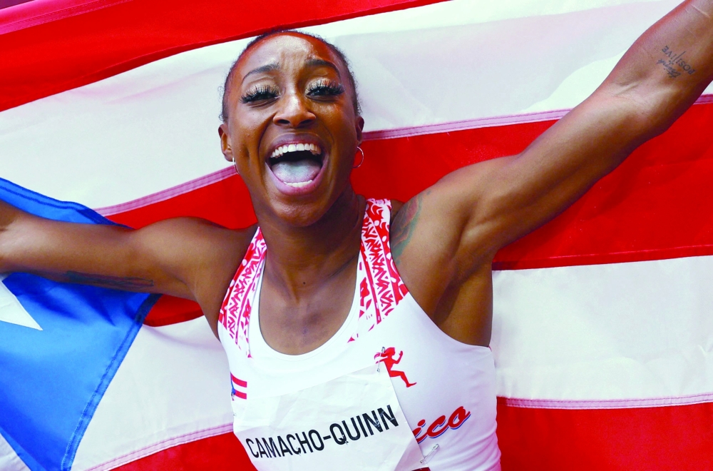 TOPSHOT - Puerto Rico's Jasmine Camacho-Quinn reacts after winning the women's 100m hurdles final during the Tokyo 2020 Olympic Games at the Olympic Stadium in Tokyo on August 2, 2021. (Photo by KAI PFAFFENBACH / POOL / AFP)


