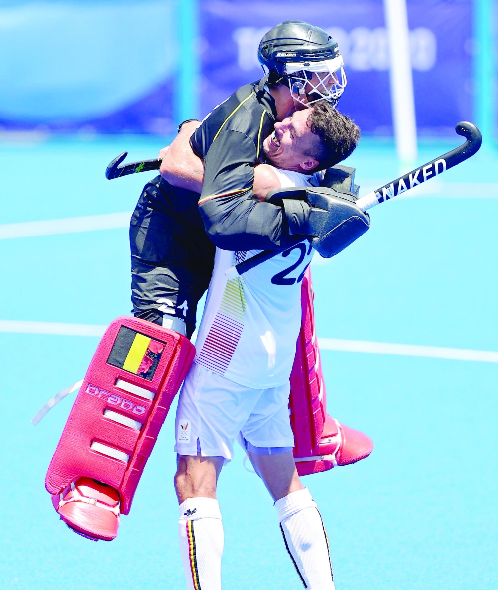 Belgium's Simon Gougnard and Vincent Vanasch celebrate after winning their match against India. -- Reuters 