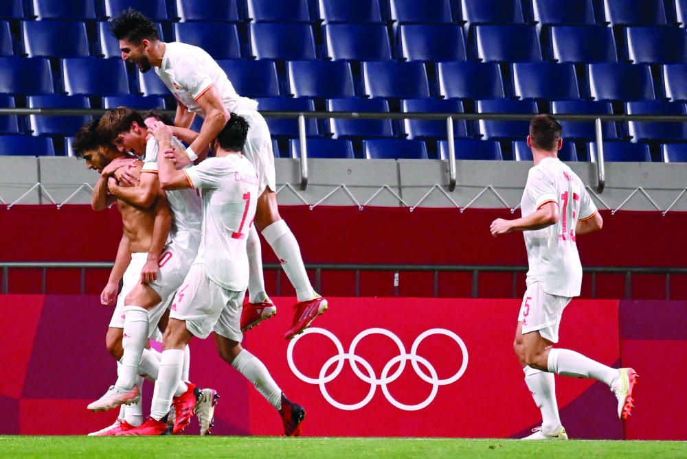 Spain's Marco Asensio (L) celebrates with teammates after scoring. -- AFP 