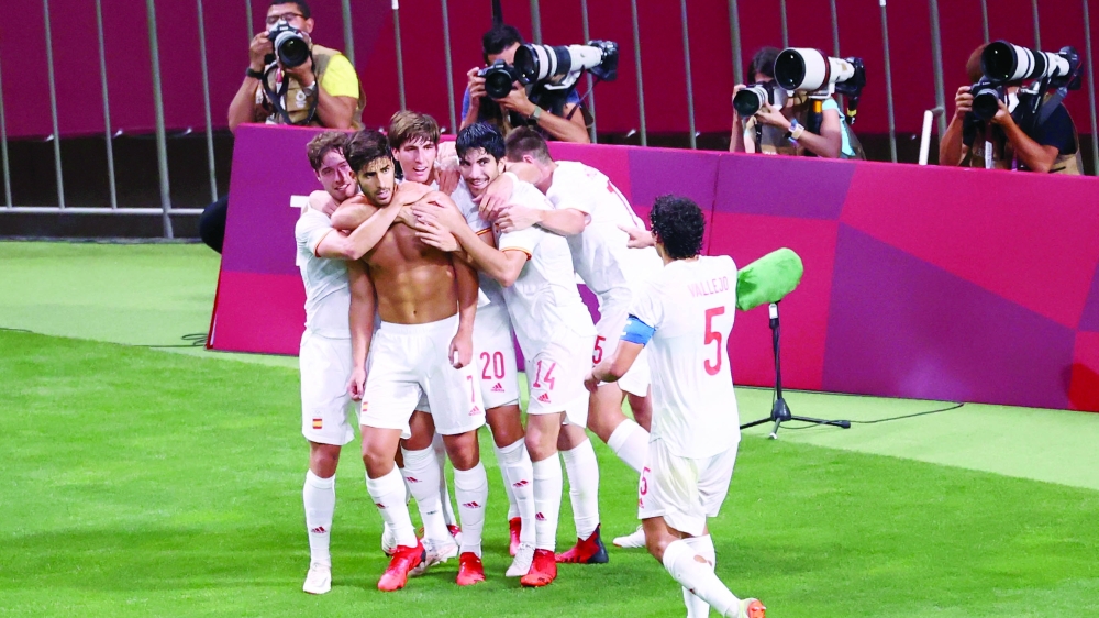 Spain's Marco Asensio celebrates with teammates after scoring. -- Reuters