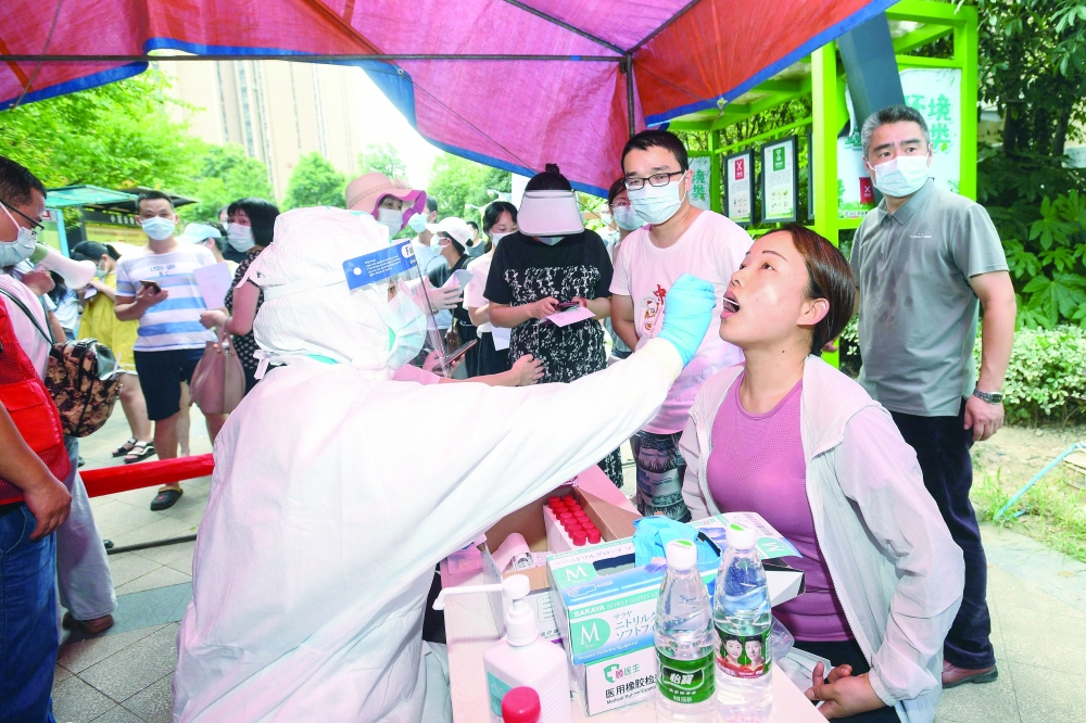 A resident is given a nucleic acid test for the coronavirus in Wuhan, in China’s central Hubei province, on Tuesday. — AFP