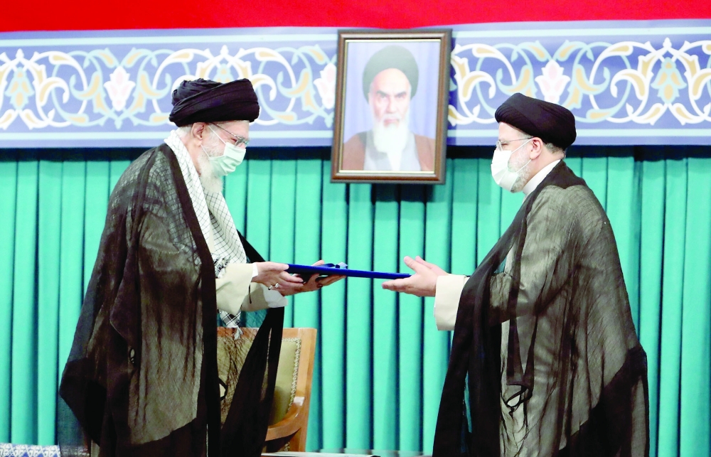 Iran’s new President Ebrahim Raisi receives the endorsement decree for his presidency from Iran’s Supreme Leader Ayatollah Ali Khamenei, in Tehran, on Tuesday. — Reuters